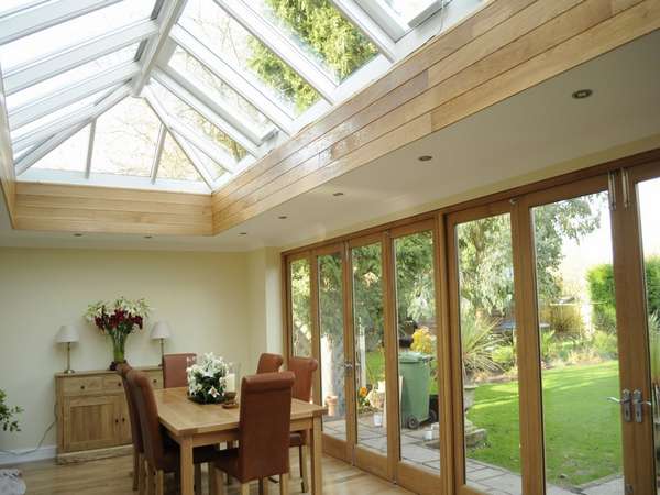 Cheadle Manchester. Internal view of a pair of G Barnsdale's Oak Bi Fold doors in there slimline section double glazed. Skylight HWL Ornate to complement the timber door. Marine Finish Aluminium with 4 no Rain censored Electric roof vents.