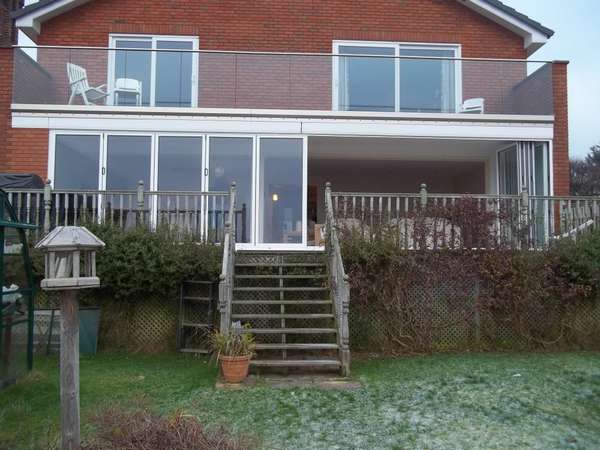 Mr & Mrs H. CALDY , WIRRAL : Installation of a set of 10m wide slimfold A10 Aluminium Bi Fold doors double glazed . Marine finsh Polyester Powder Coated Std white . CLL Balastrading glazed with heat- soak 15mm toughened Laminated glass