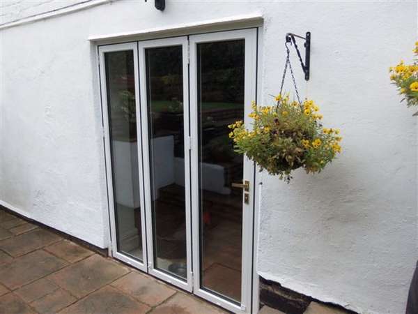 Mr J. : Oxton Wirral. Installation of FSD Aluclad slimfold AC10 Bi fold doors; Oak internal - White Marine finish Aluminium external